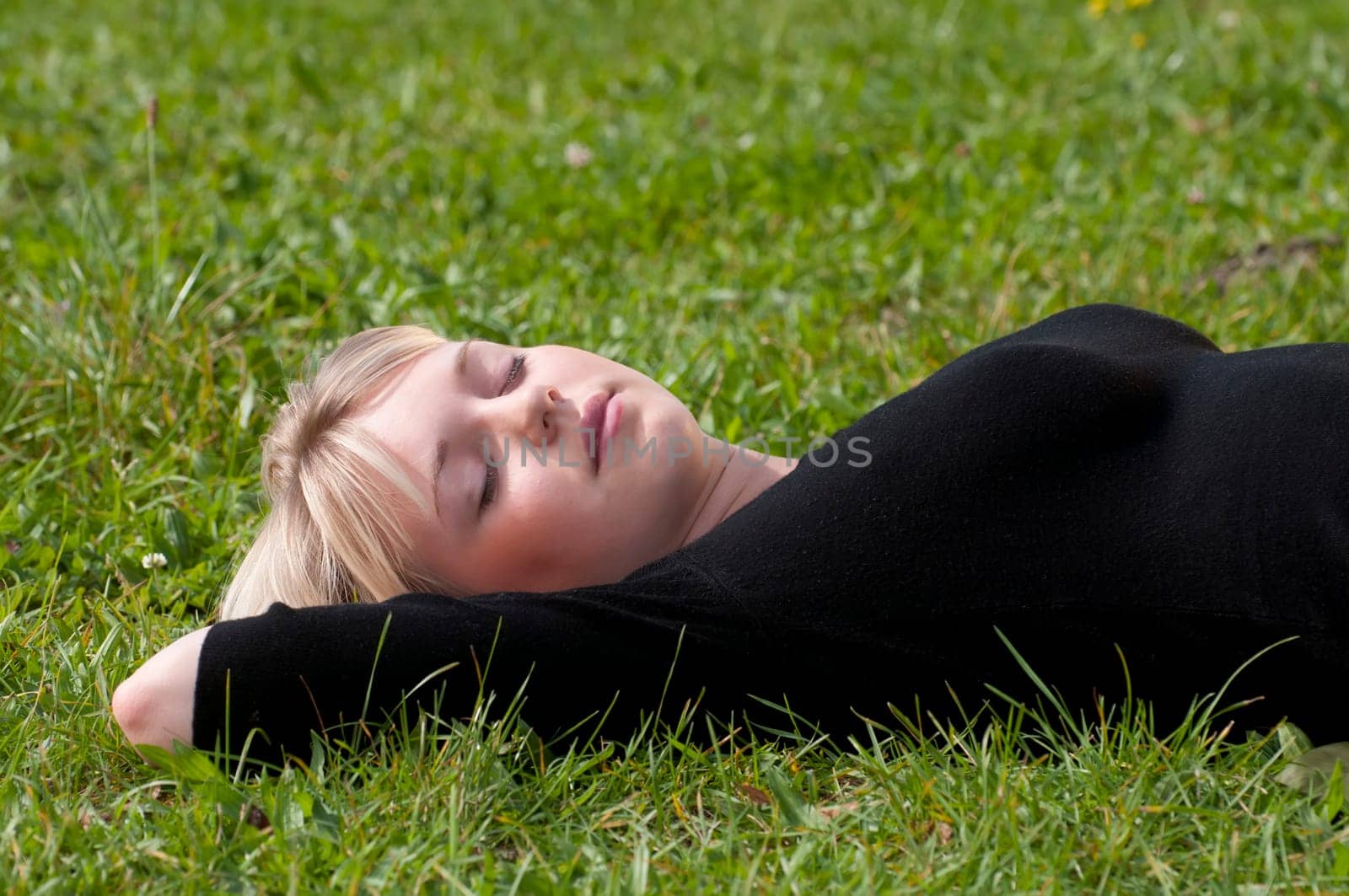 Young woman lying on a meadow