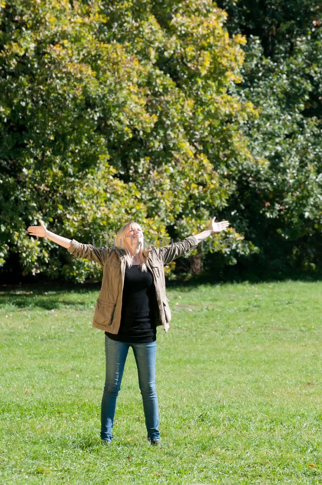 Young woman spreads her arms