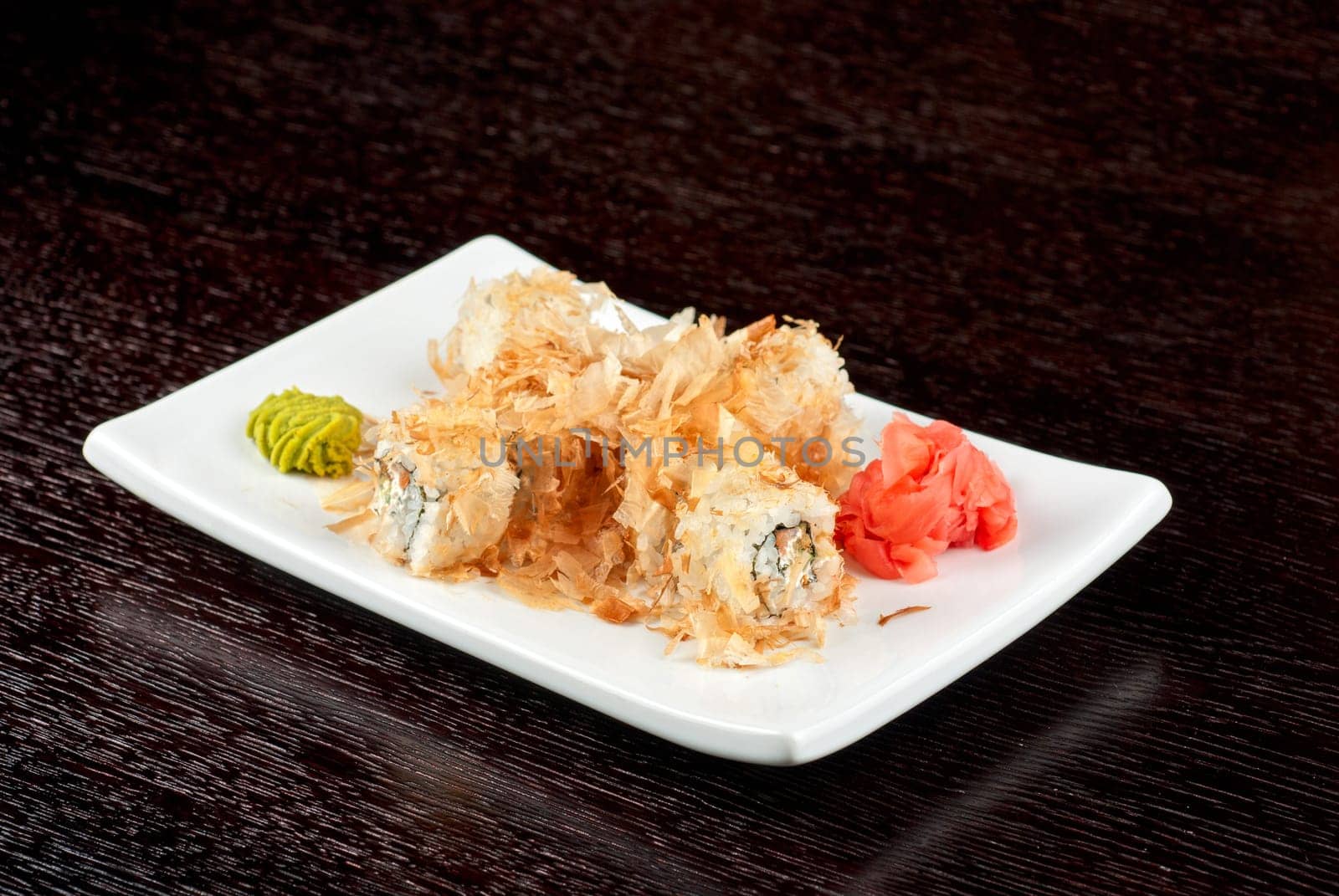 Sushi rolls of rice, nori, cream cheese, avocado, smoked salmon,cucumber and cuts of tuna