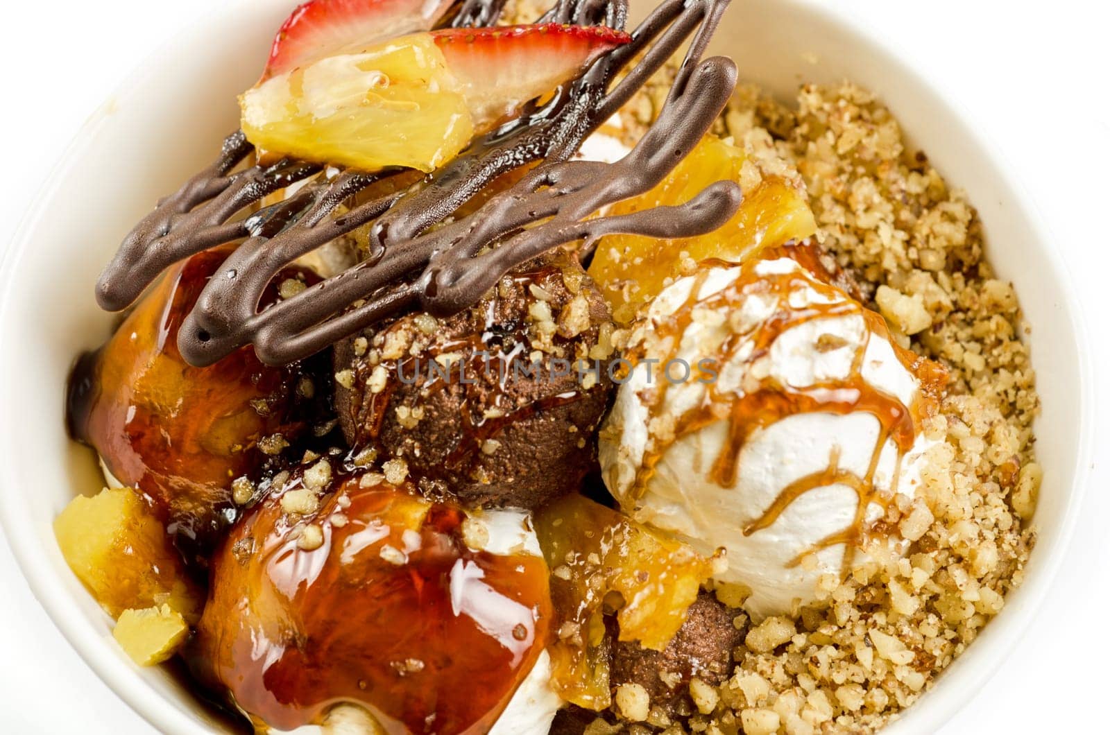 ice cream with chocolate, nuts and caramel close up