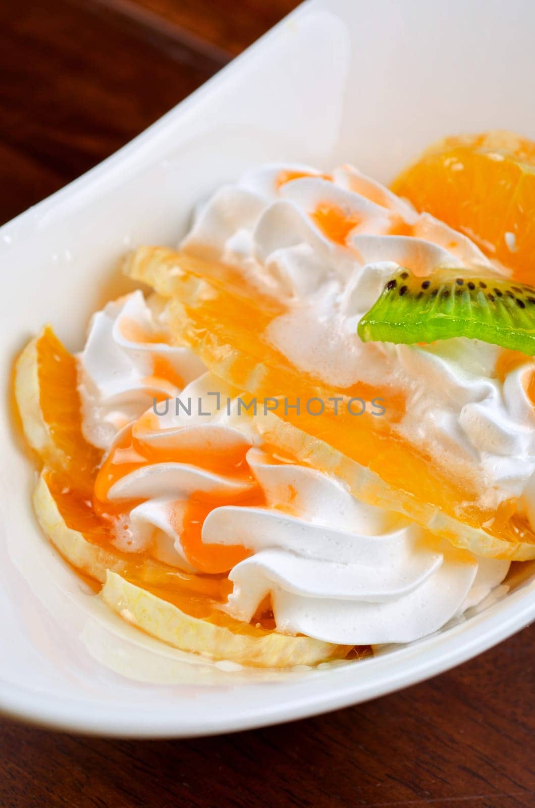 Ice cream dessert with kiwi, strawberry and orange