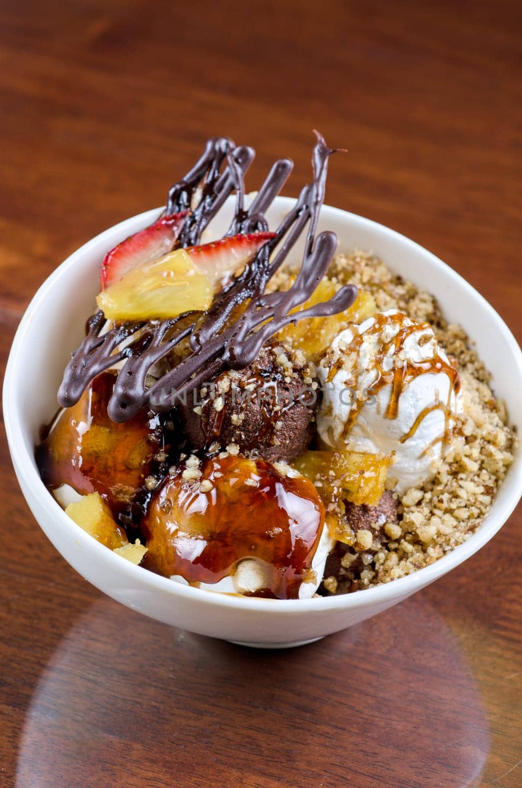ice cream with chocolate, nuts and caramel close up