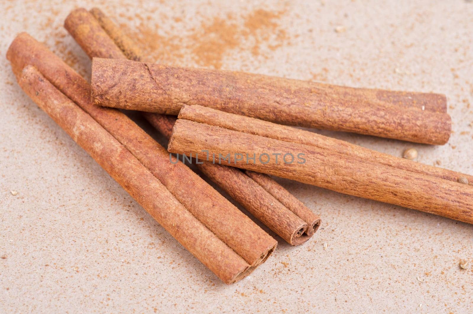 Cinnamon stick closeup on a brown background