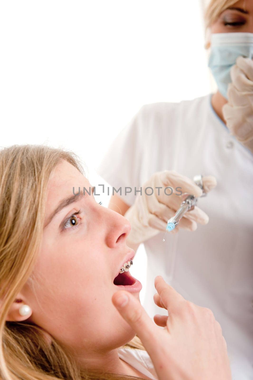 Young girl at the dentist scared of the injection