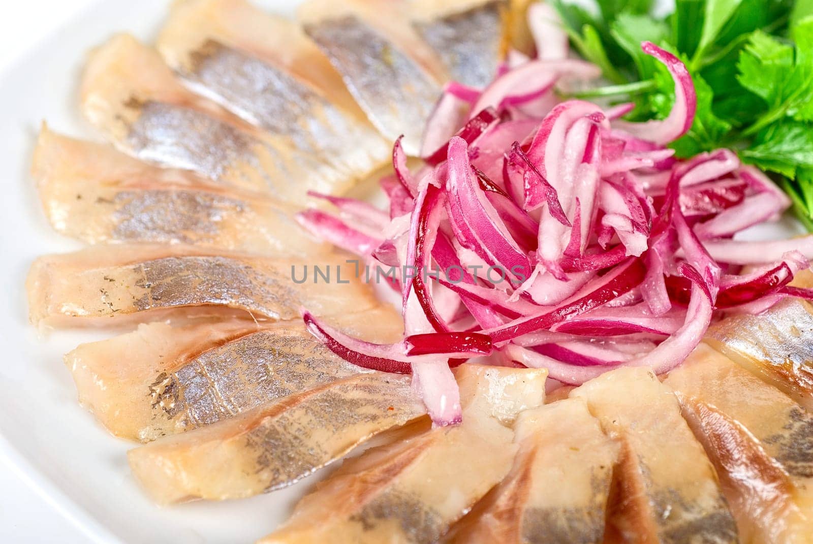 Marinated herring fillets closeup with onion
