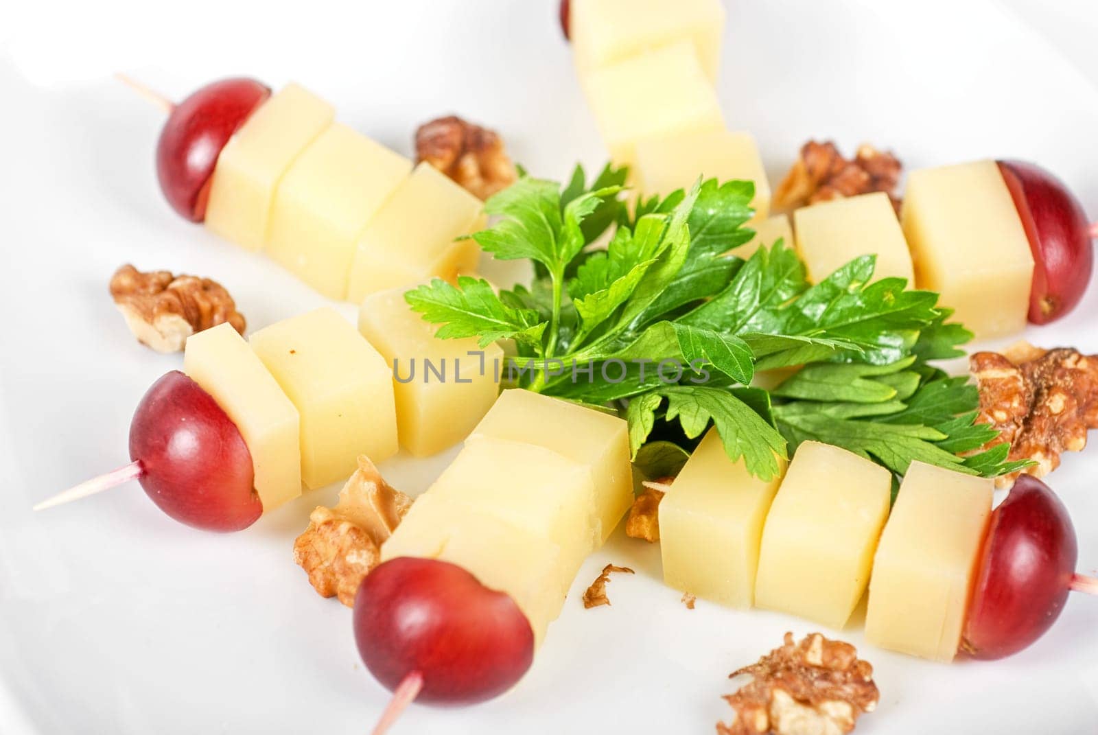 different cheese and grapes and nuts close up composition