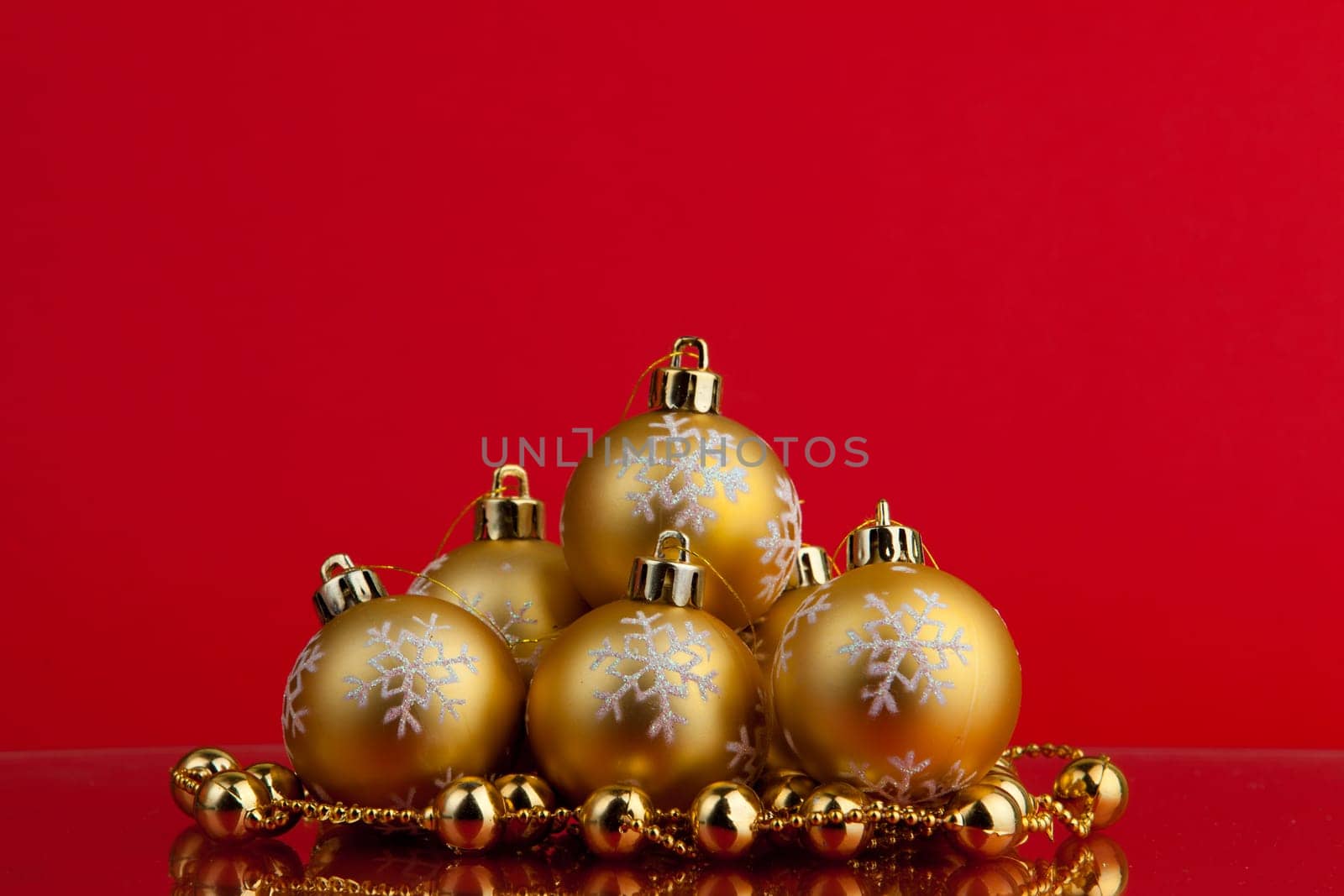 golden christmas balls of red background