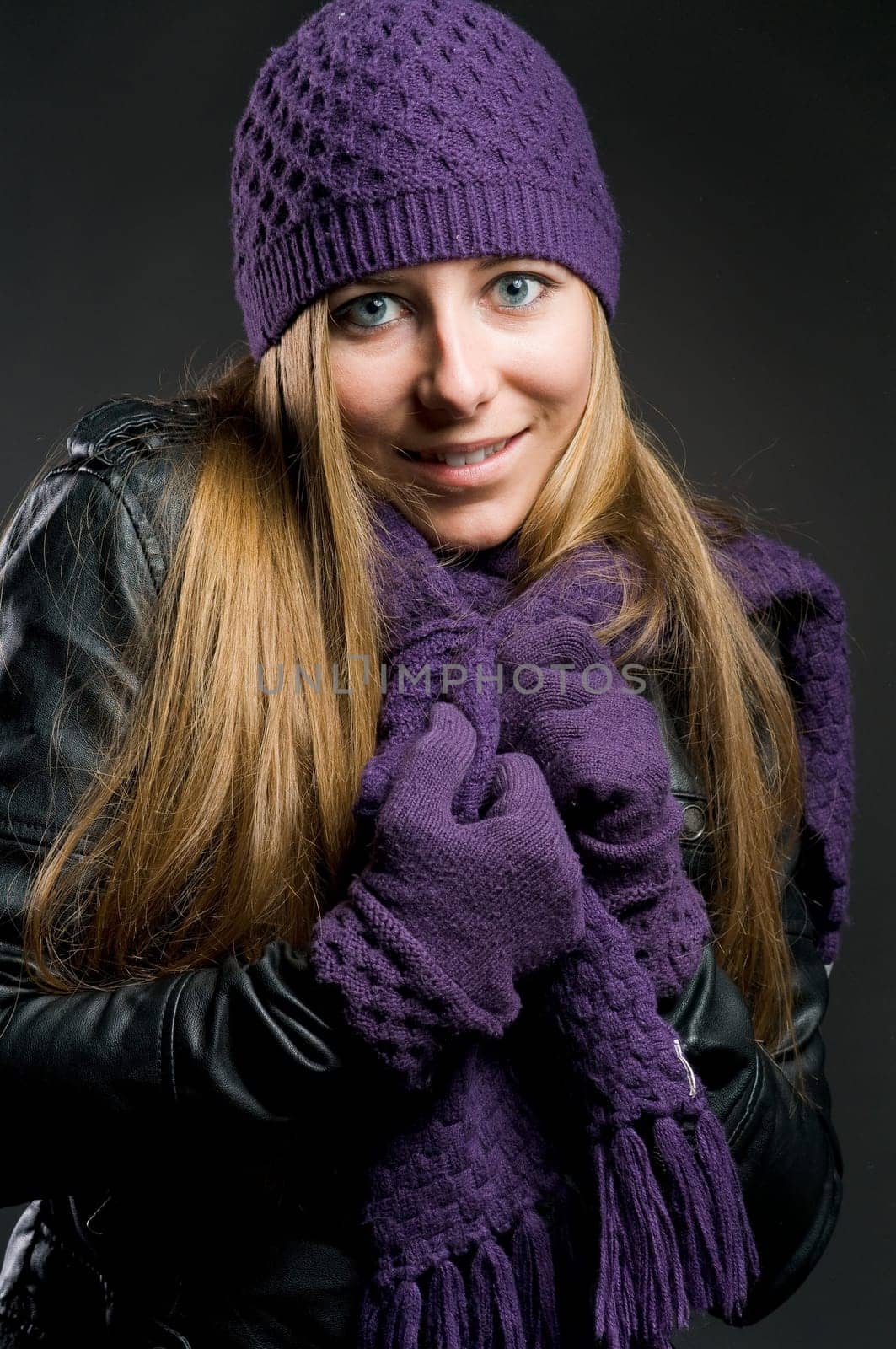 Woman with leather jacket,hat,scarf and gloves