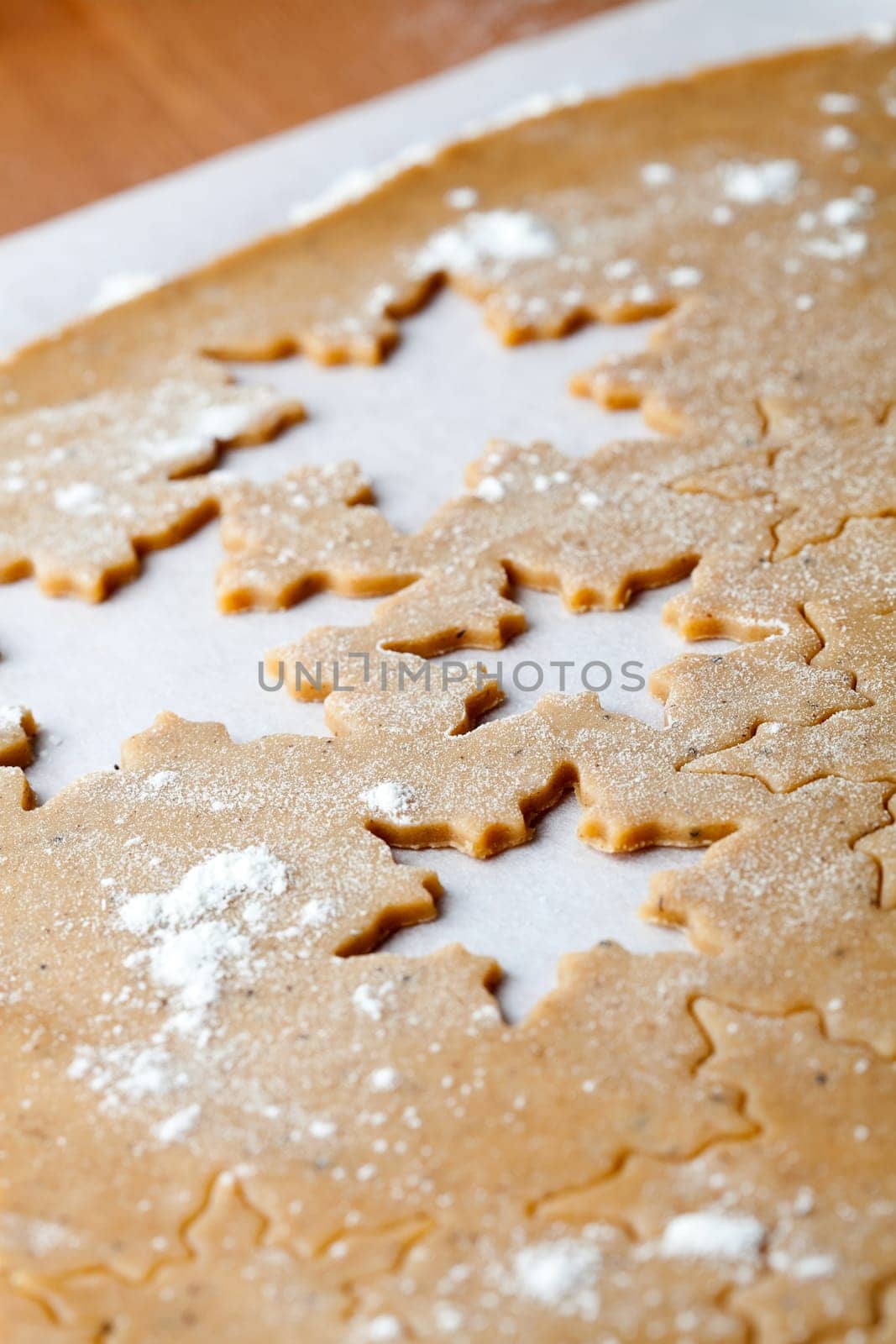 Making gingerbread cookies for Christmas. Gingerbread dough with star shapes.