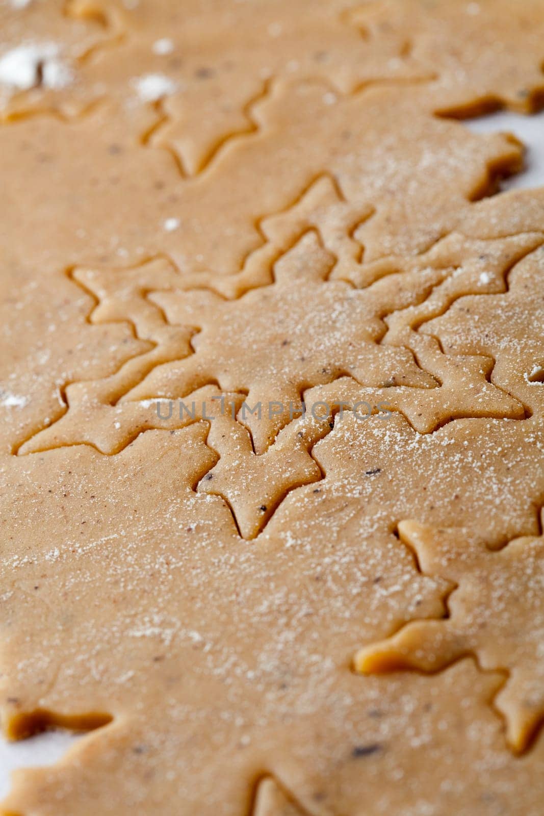 Making gingerbread cookies for Christmas. Gingerbread dough with star shapes.