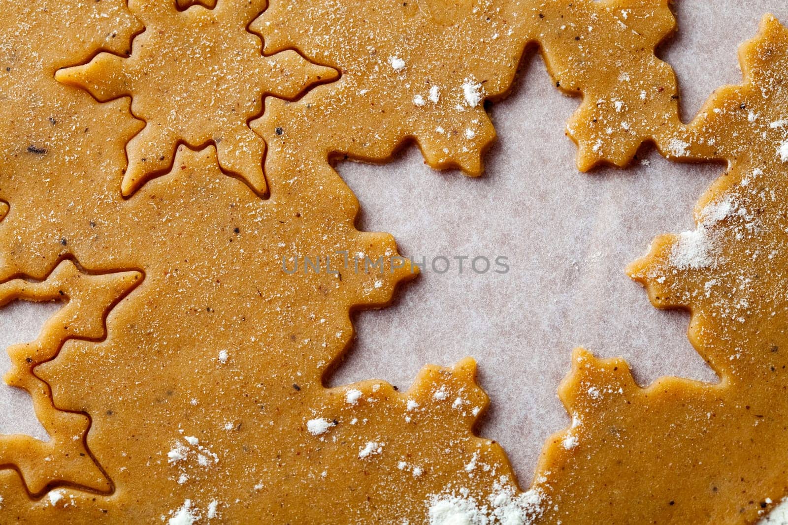 Making gingerbread cookies for Christmas. Gingerbread dough with star shapes.