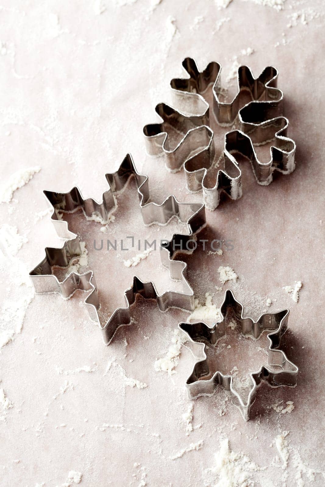 Close-up of metallic gingerbread cutters, star shape and snowflake