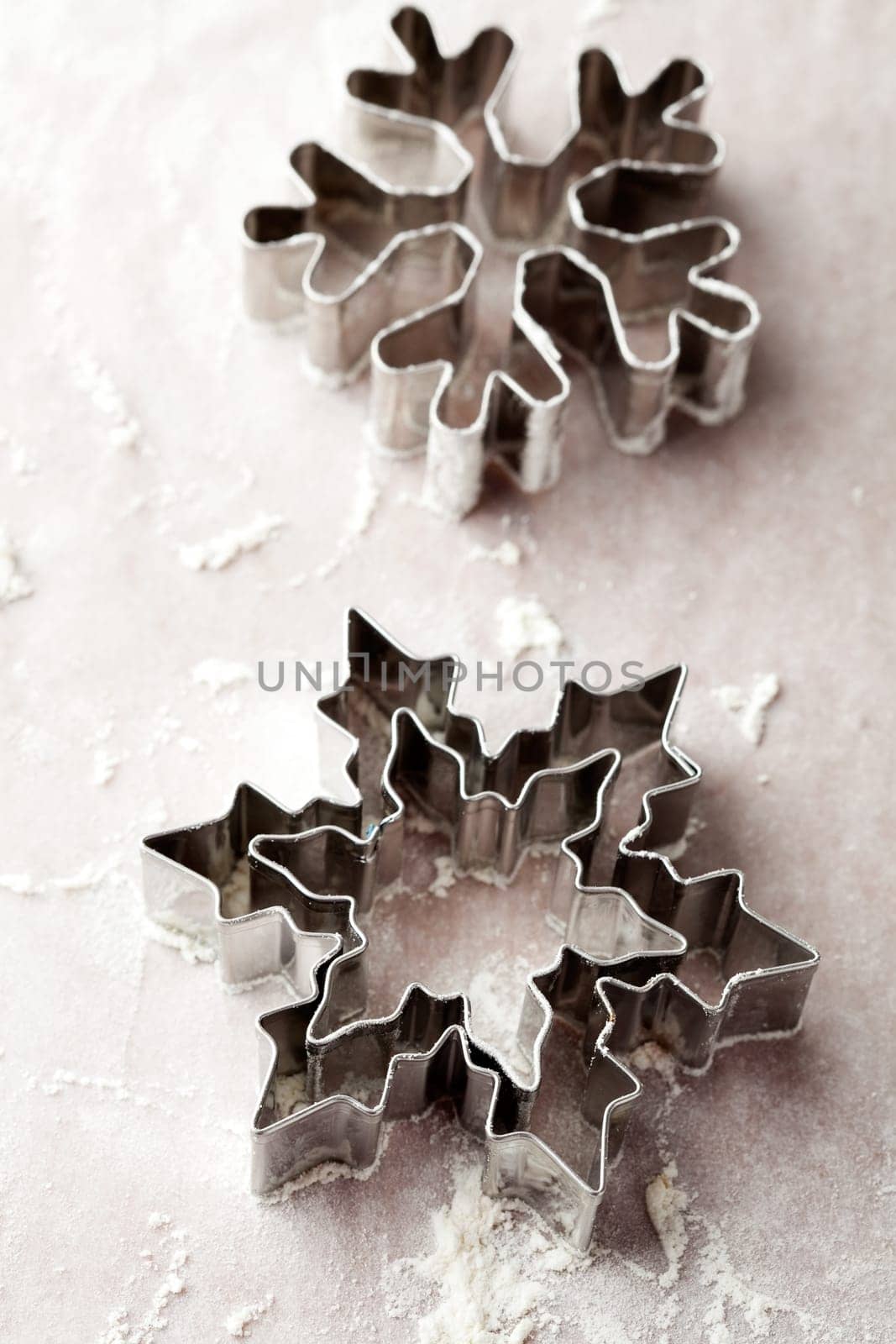 Close-up of metallic gingerbread cutters, star shape and snowflake