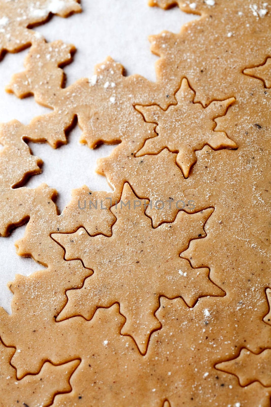 Making gingerbread cookies for Christmas. Gingerbread dough with star shapes.