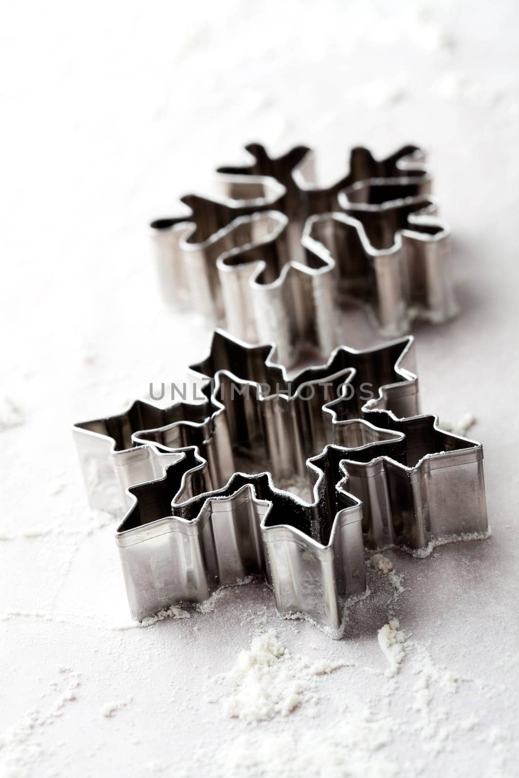 Close-up of metallic gingerbread cutters, star shape and snowflake