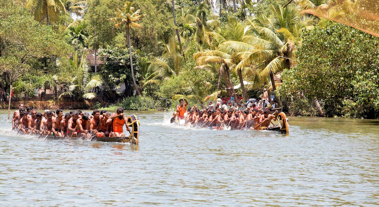 North Paravoor, Gothuruth, Kerala, India, Asia - September 25th, 2011: Gothuruth Boat Race two snake boats racing to the finish line neck and neck, crop margin copy space horizontal landscape