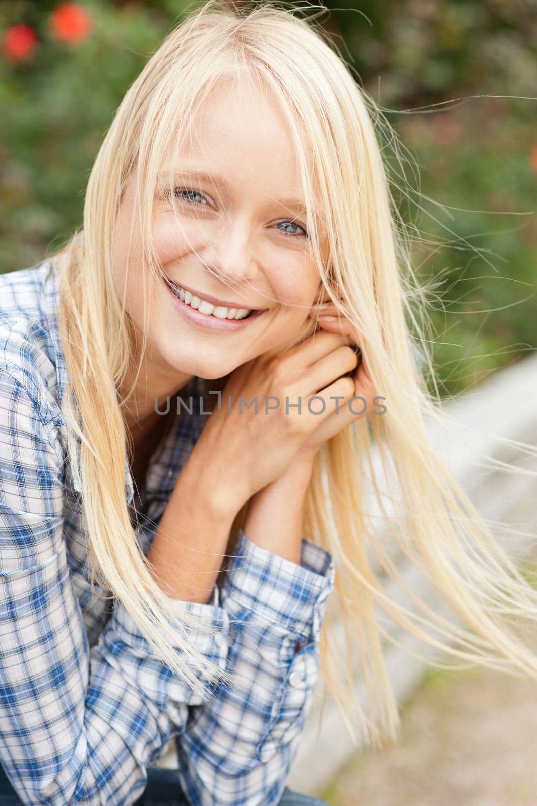 Portrait of a young and smiling woman in the park