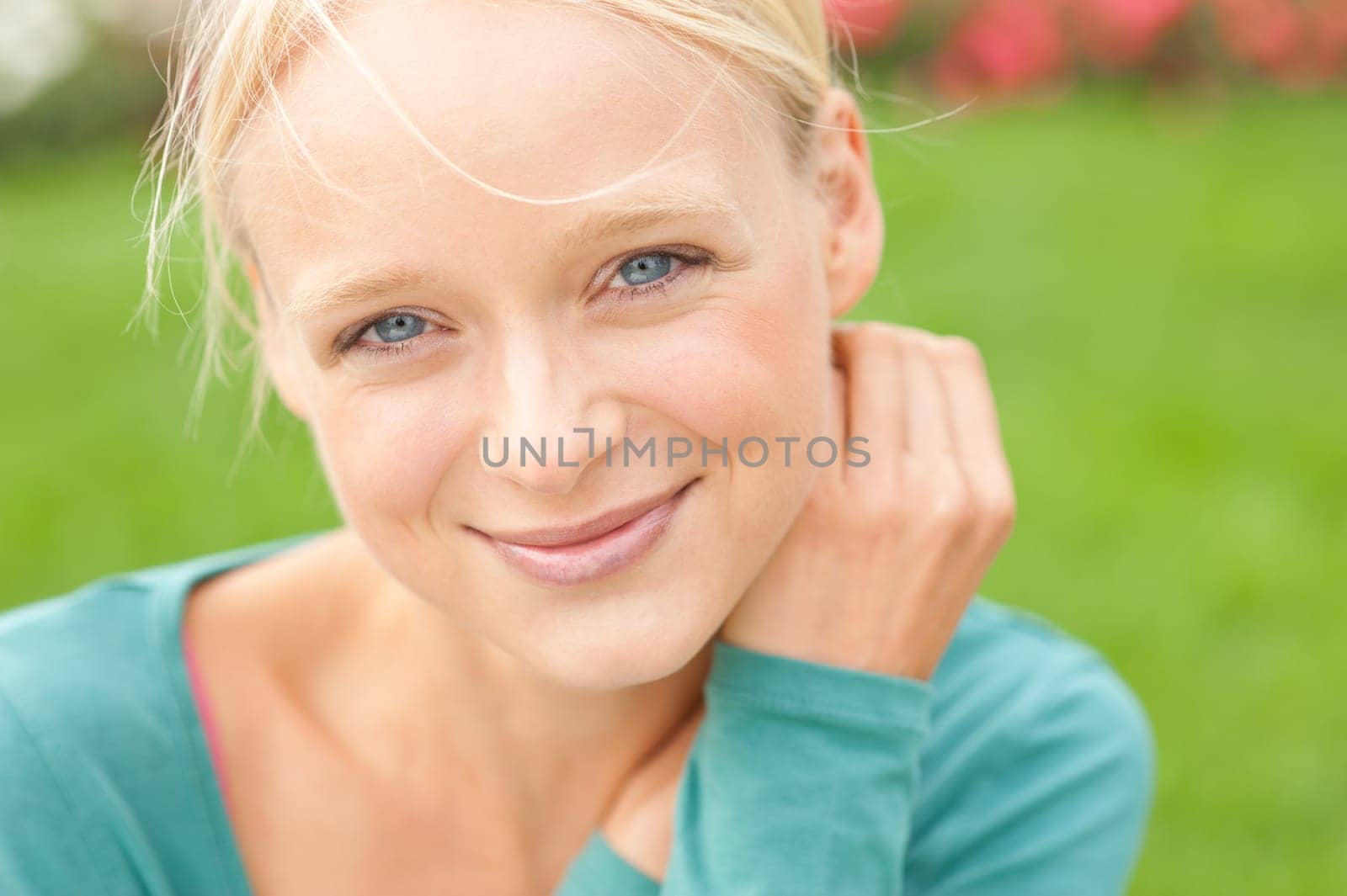 Portrait of a young and smiling woman in the park