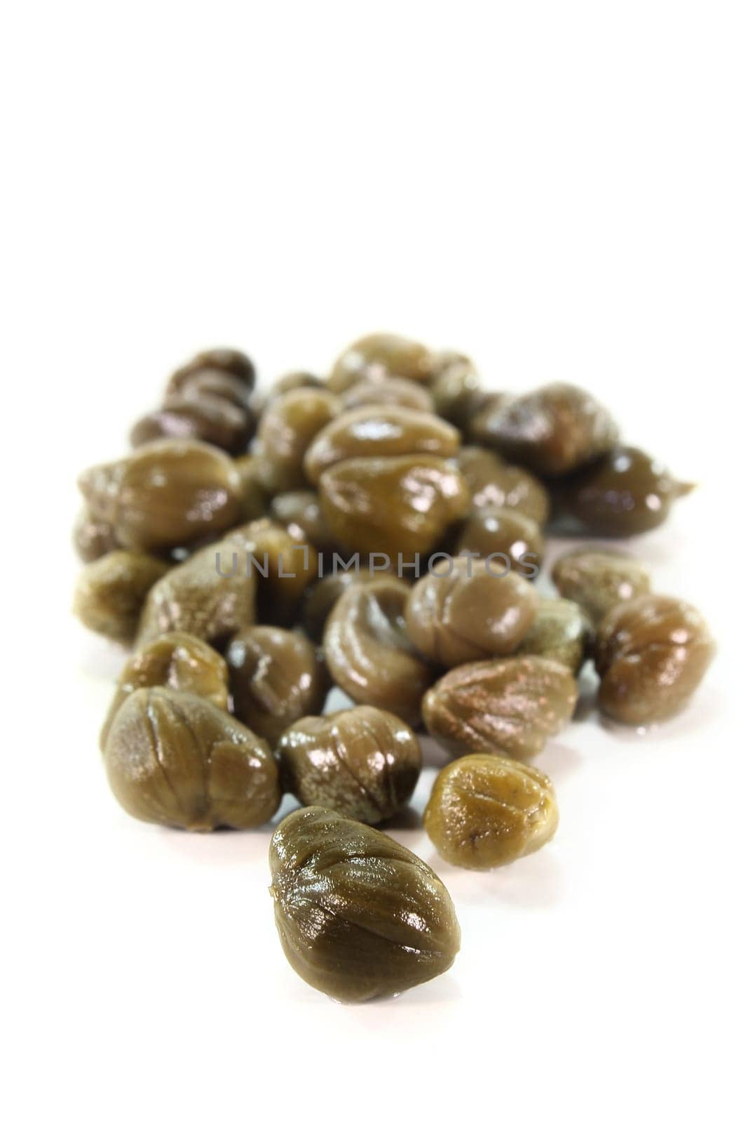 Pickled caper fruits on white background
