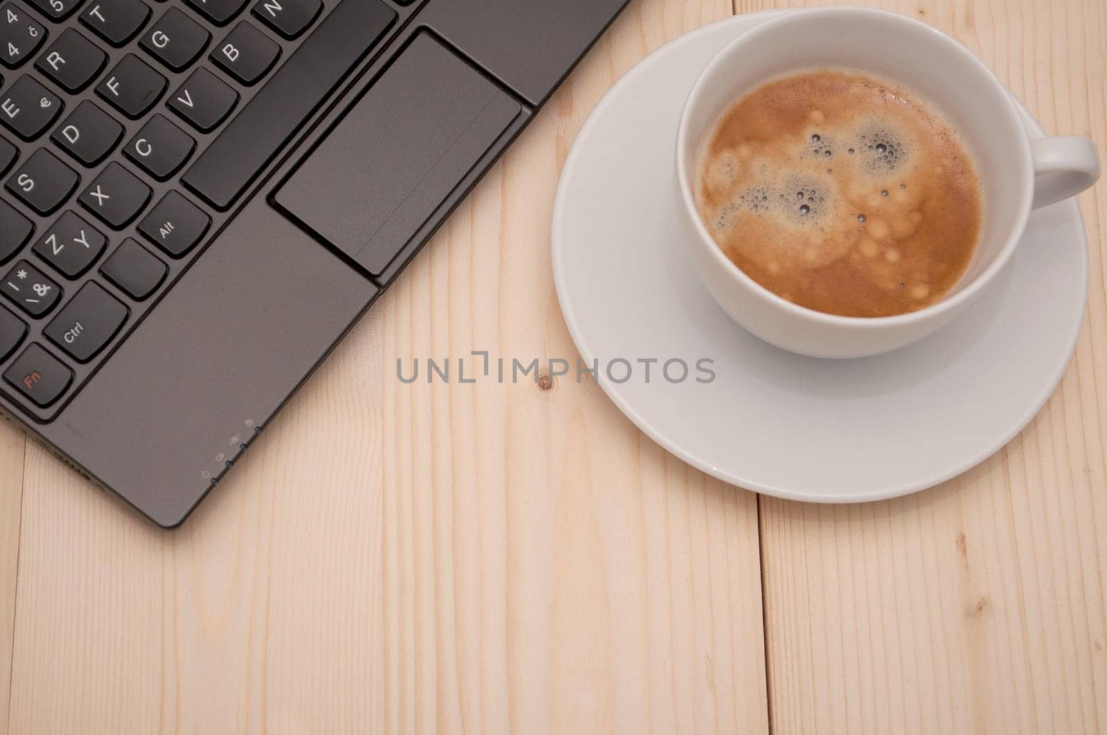 Laptop and Espresso Coffee on Wooden Table