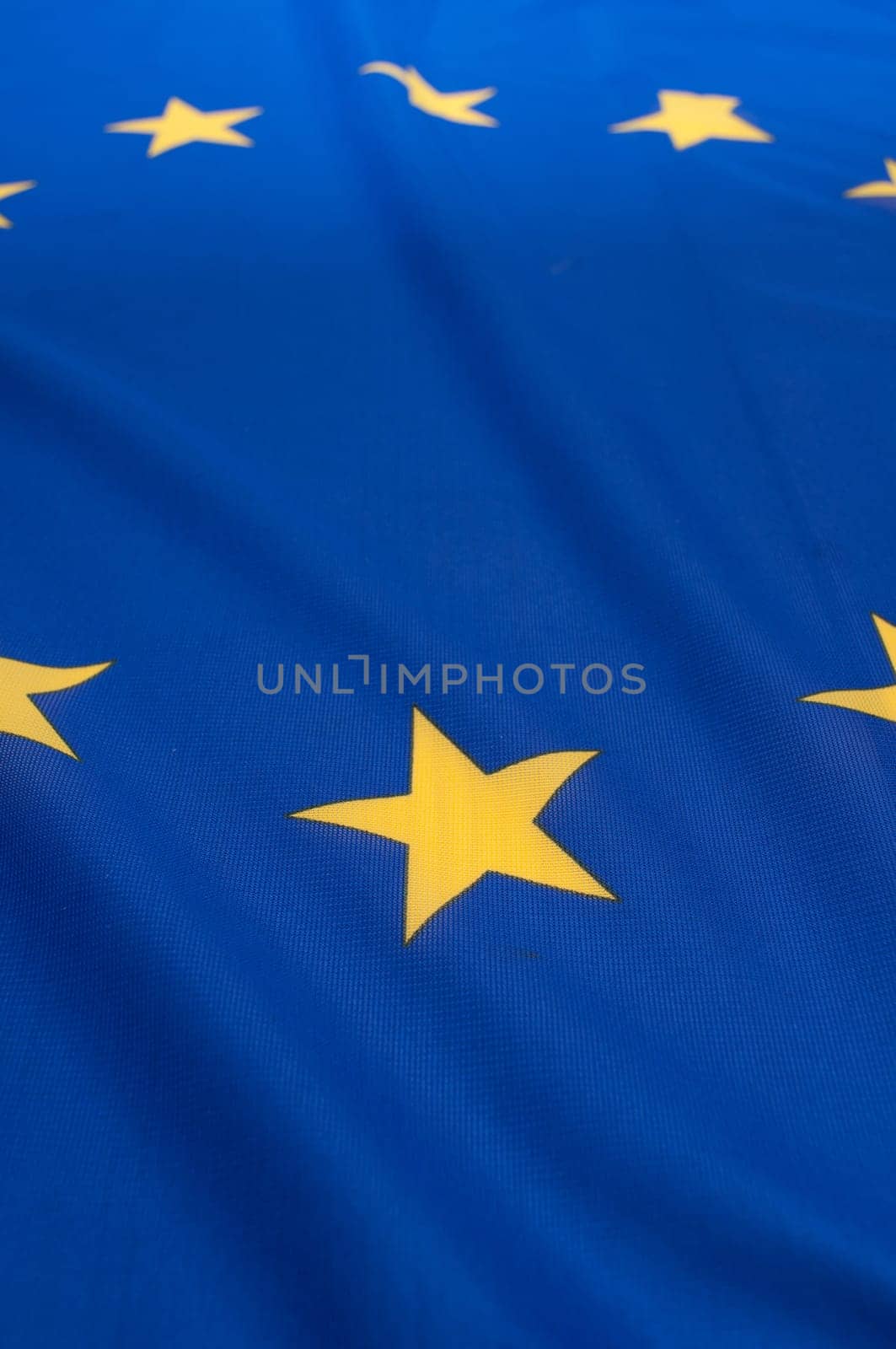 Detail of Silky Flag of Blue European Union EU Flag Drapery - Shallow Depth of Field