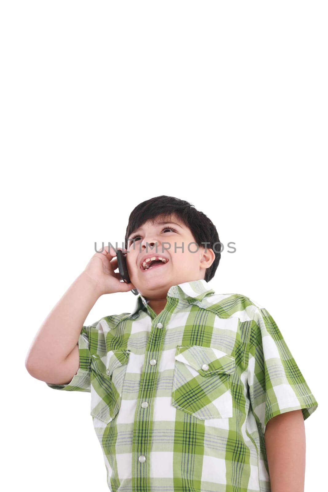 Beautiful little boy  laughs and talks by mobile phone.