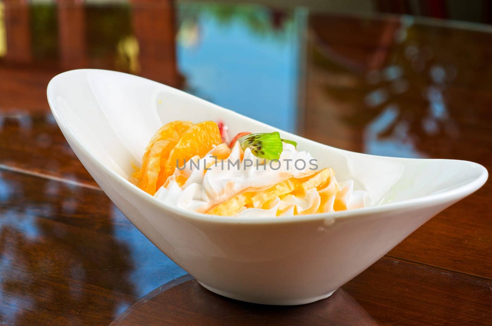 Ice cream dessert with kiwi, strawberry and orange