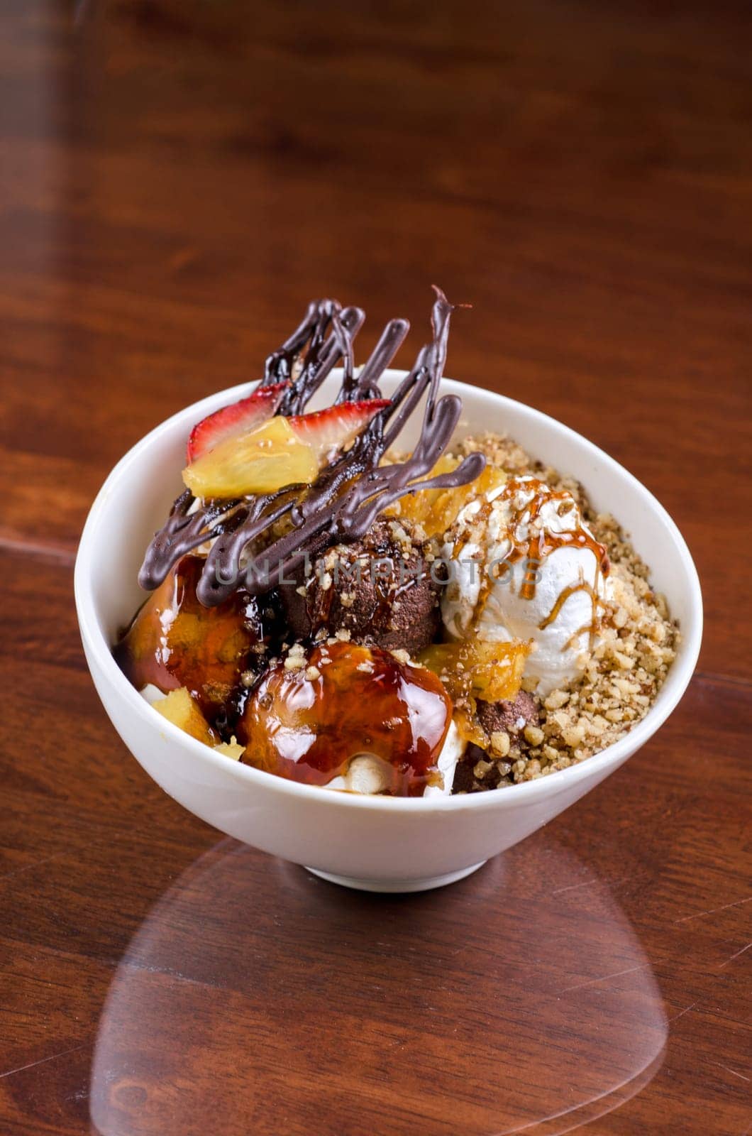 ice cream with chocolate, nuts and caramel close up