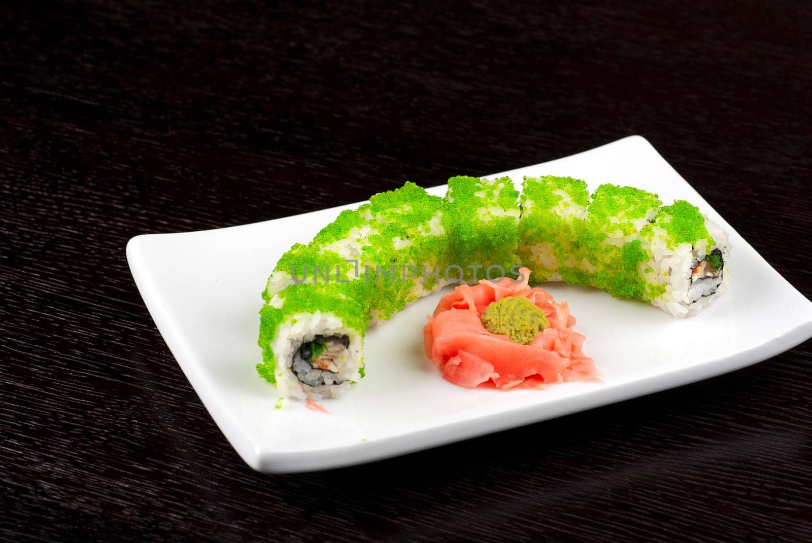 Sushi rolls made of salmon, avocado, flying fish roe - tobiko caviar and philadelphia cheese