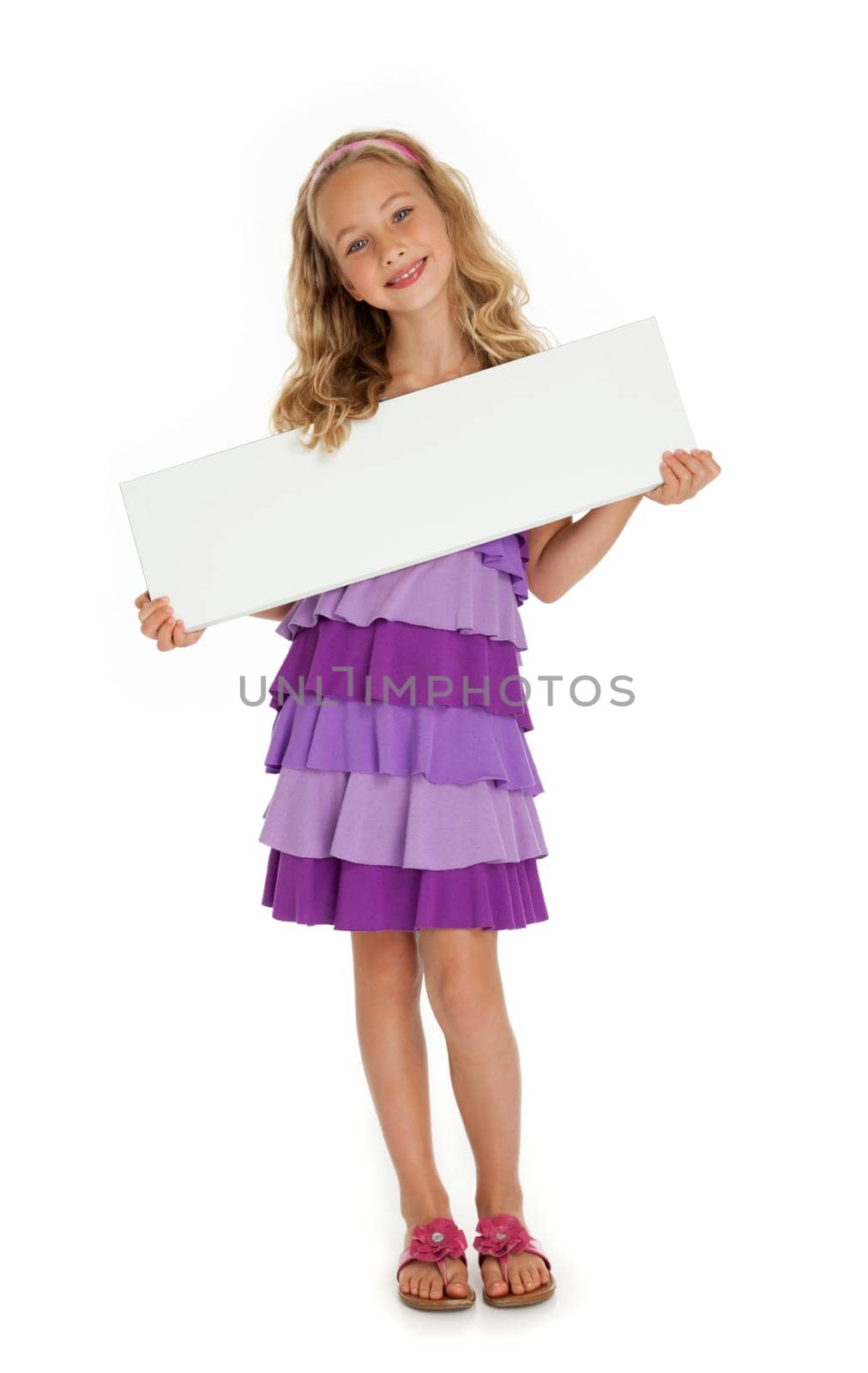 Full length photo of young girl standing, holding blank sign on white background.