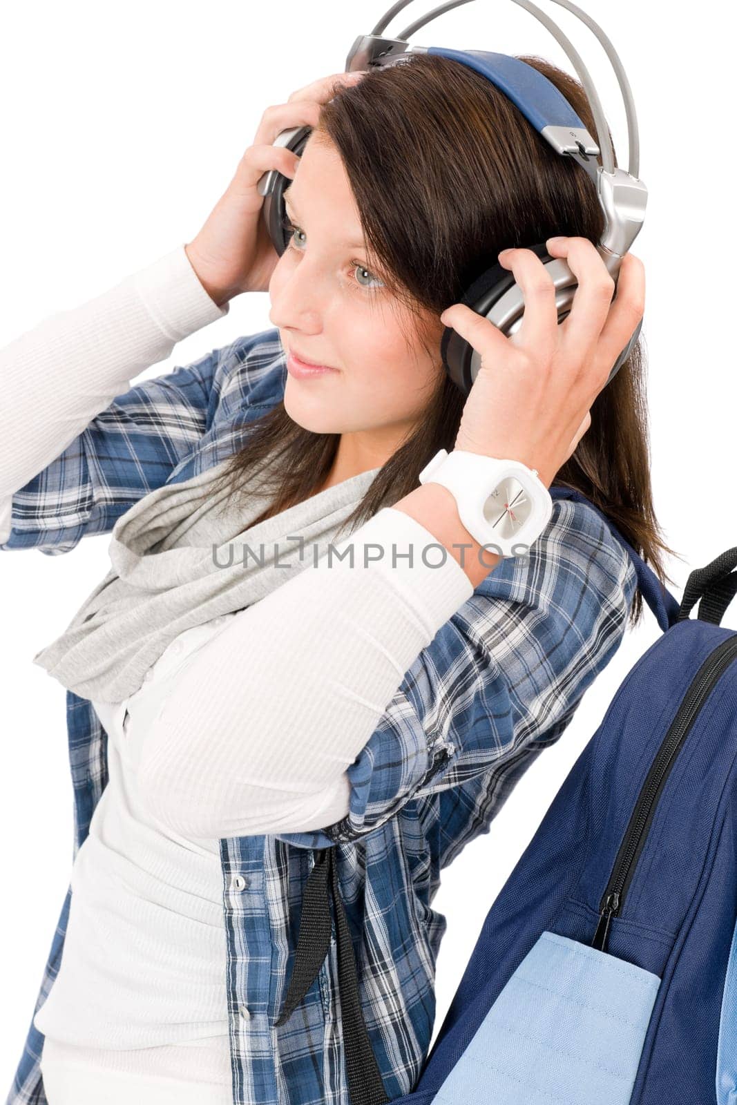 Happy female teenager enjoy music with headphones and baseball cap