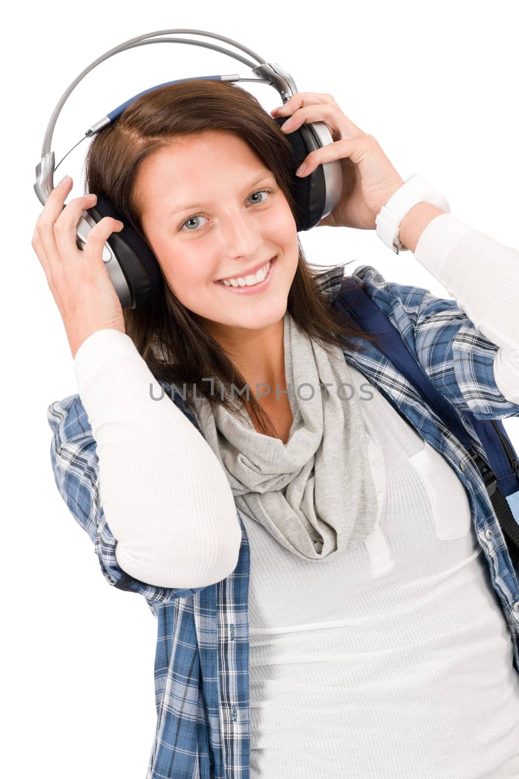 Smiling female teenager enjoy music with headphones and baseball cap