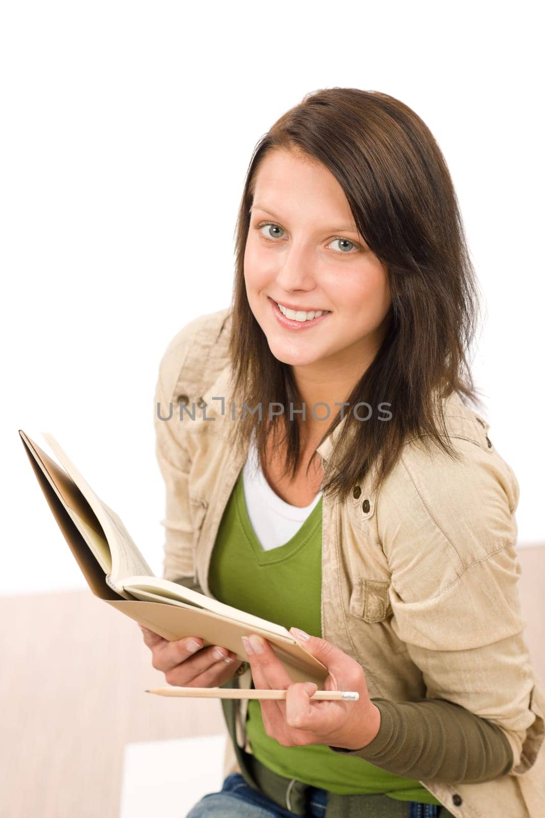 Student teenager girl holding books looking up to camera
