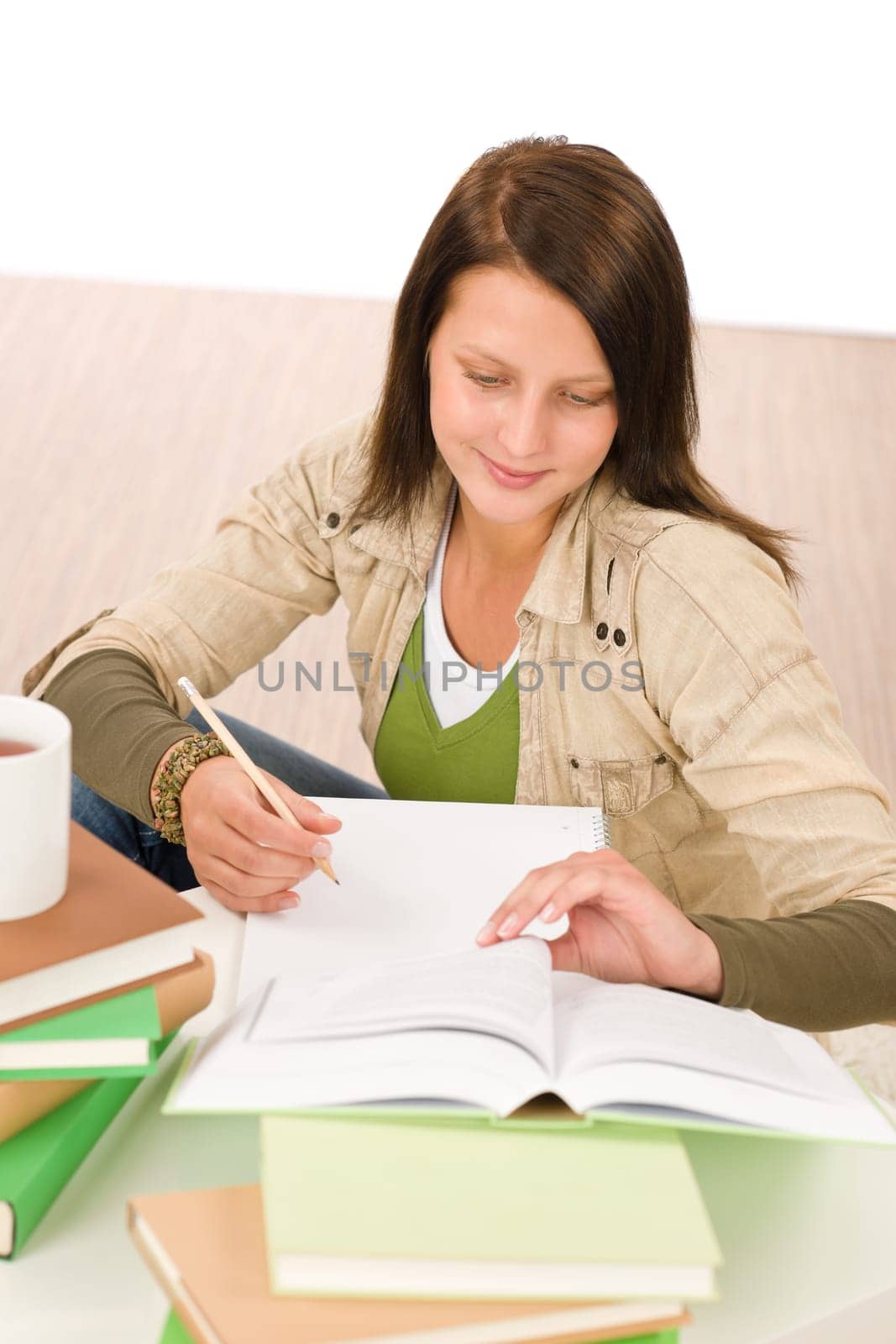 Student teenager happy girl write homework with book