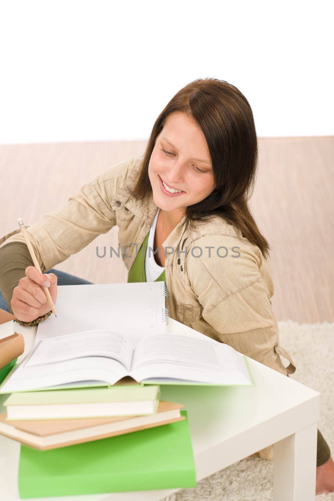 Student teenager happy girl write homework with book