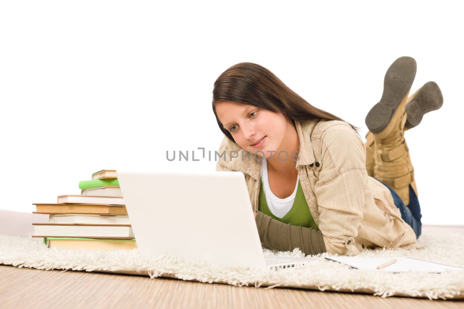 Student teenager happy girl looking laptop lying floor on carpet