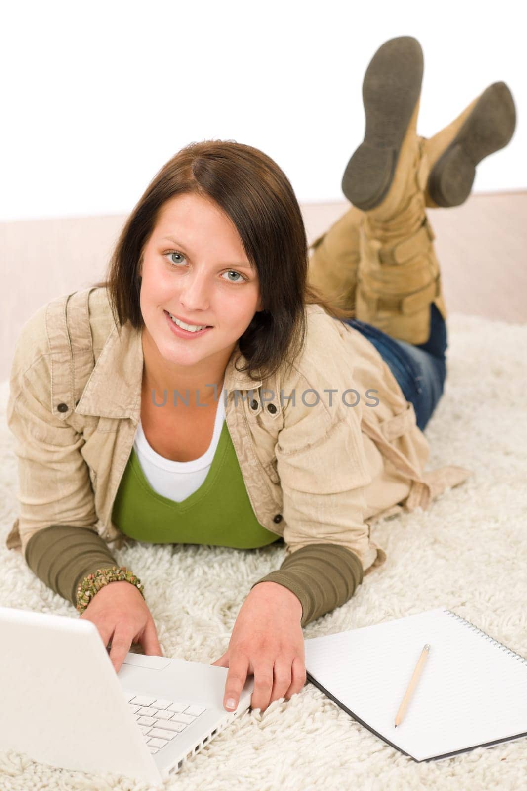 Student teenager happy girl looking laptop lying floor on carpet