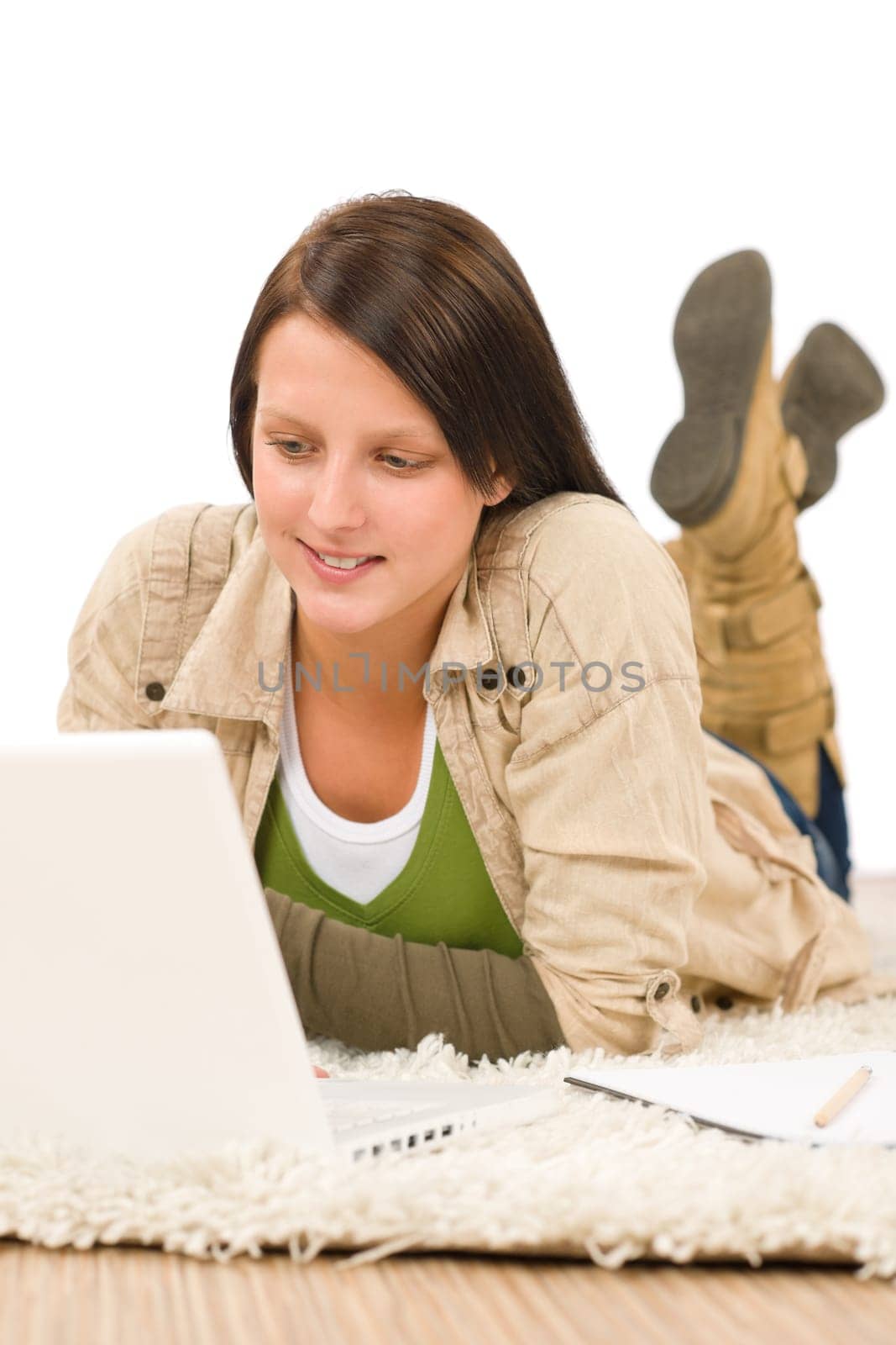 Student teenager happy girl typing laptop lying floor on carpet