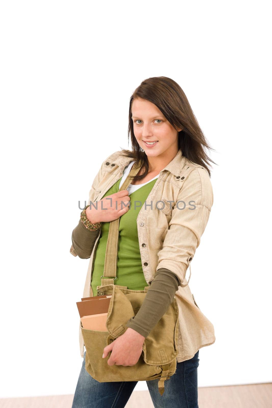 Student teenager girl with schoolbag posing looking at camera