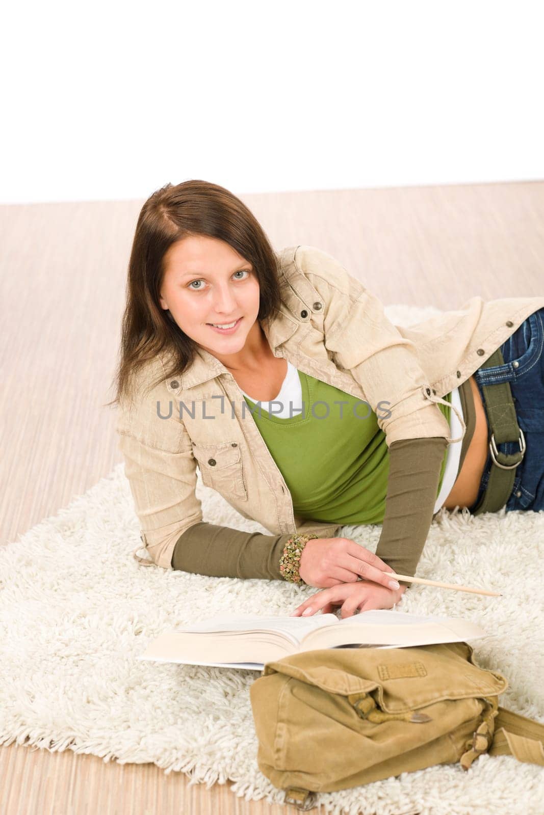 Student female teenager read book lying on floor carpet
