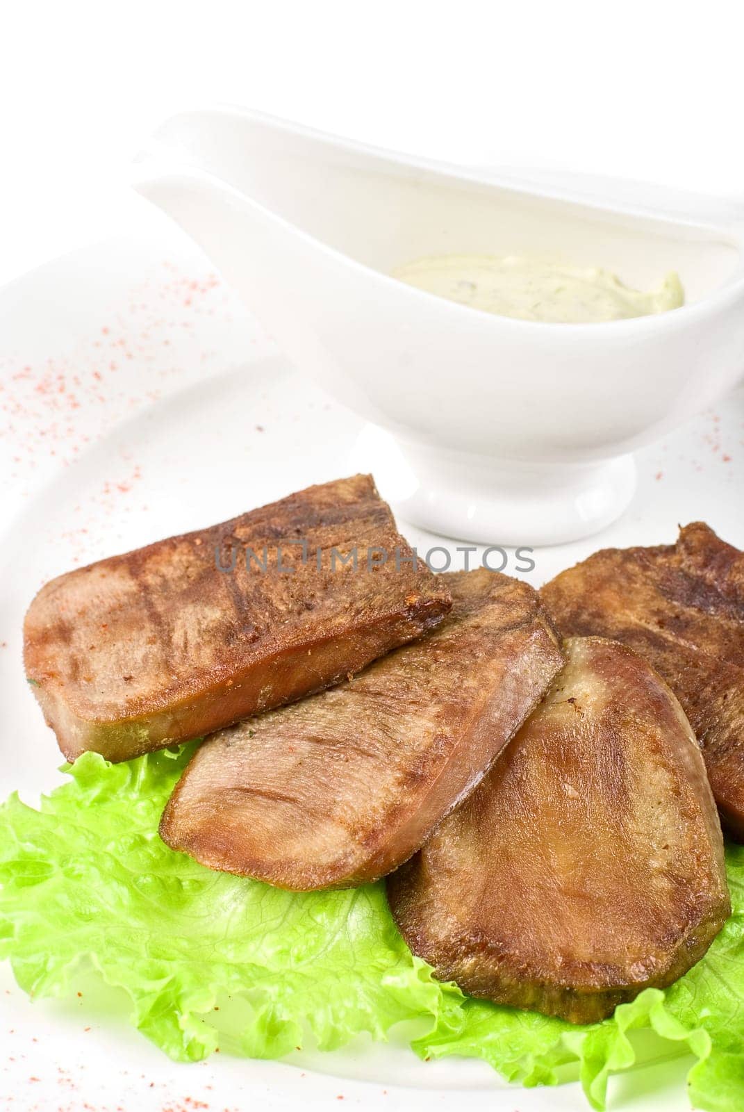 Beef tongue with sauce isolated on a white background
