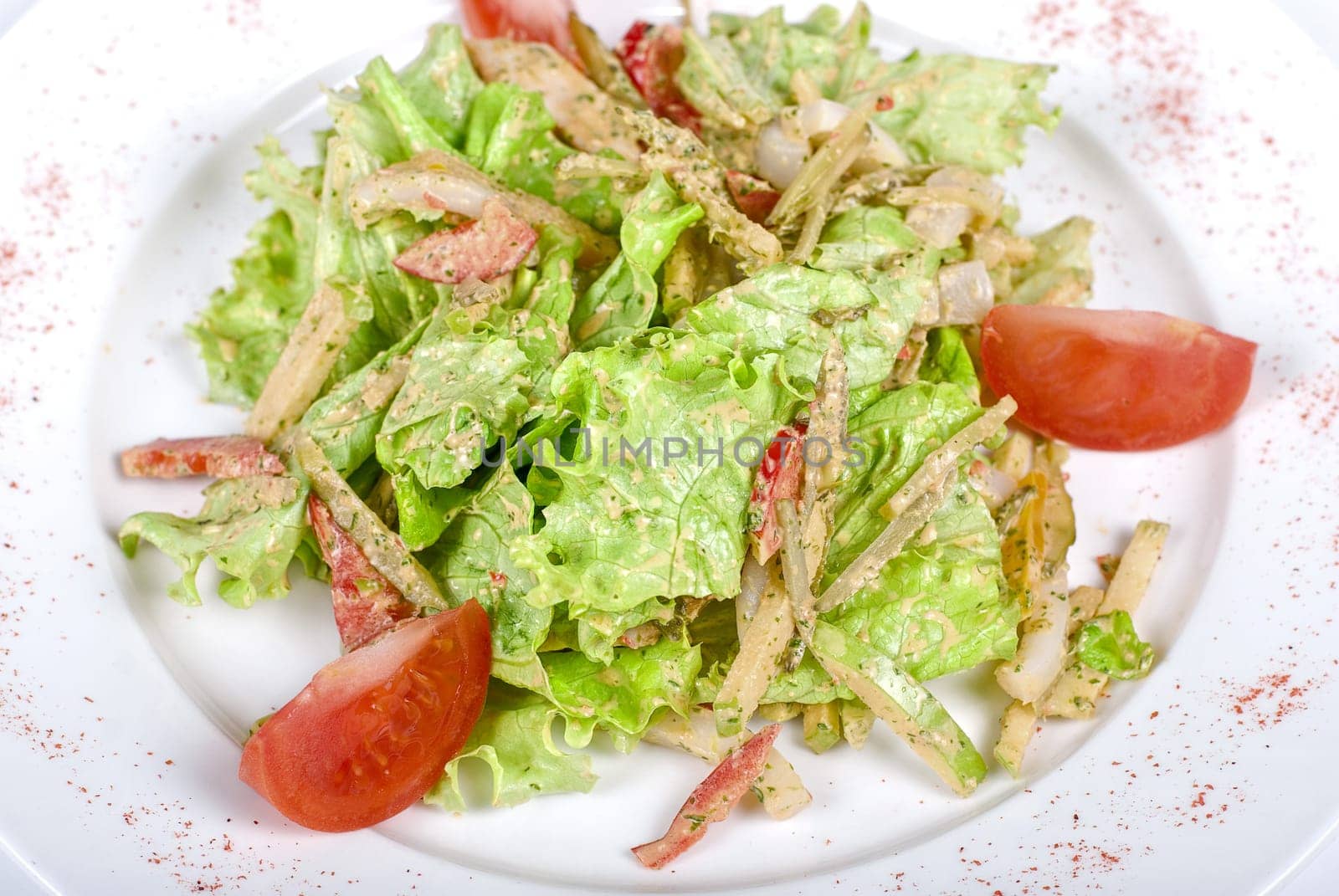 Salad of squid with roast chicken meat, apples, tomatoes, eggs and peppers