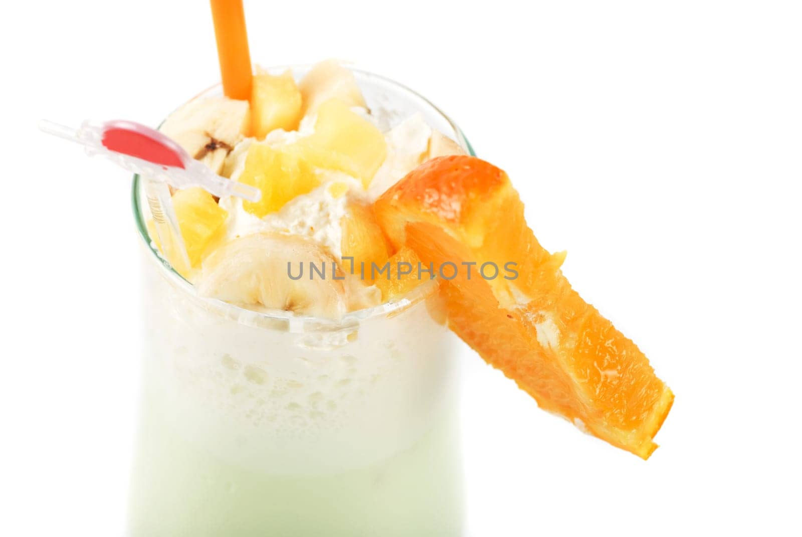 milk fruit cocktail with slice of orange cream and pipe