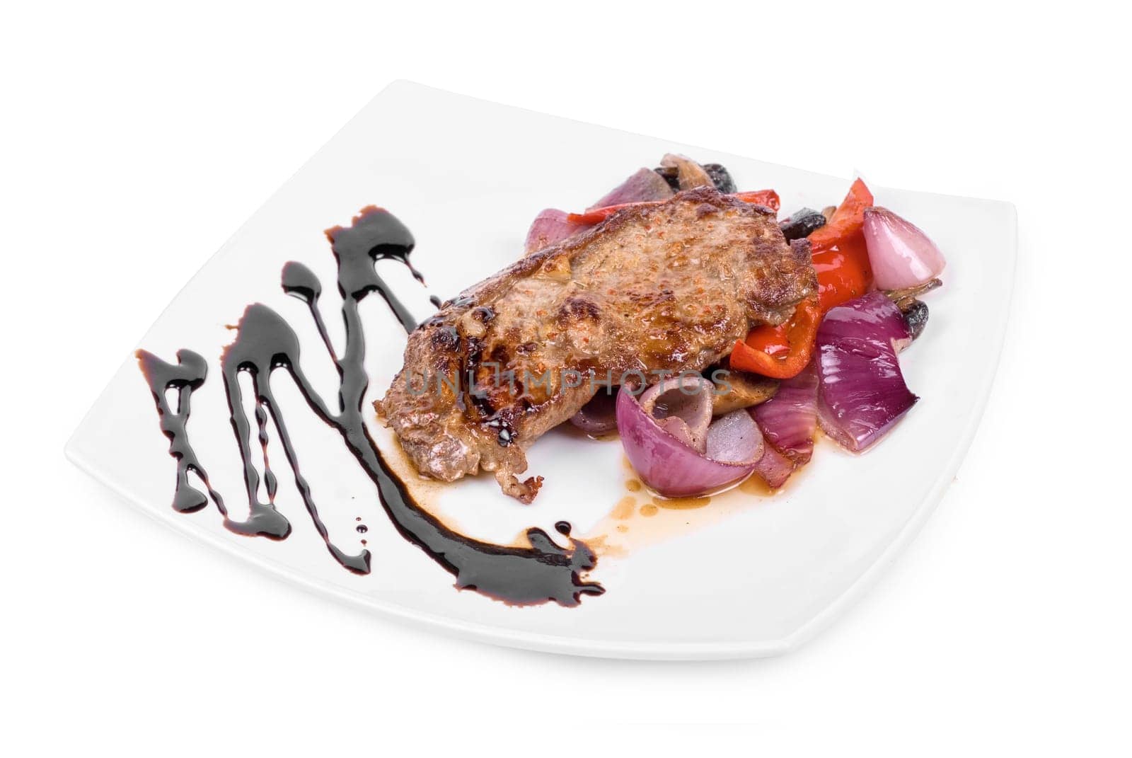 Roasted beef steak with vegetable closeup at plate