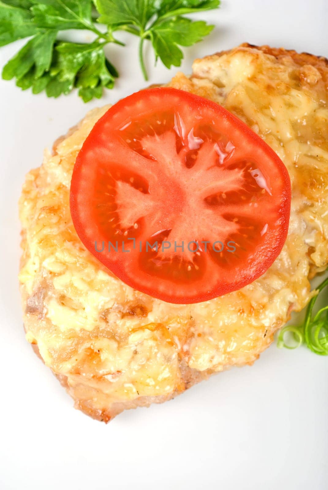 Roasted pork steak baked with cheese and tomato