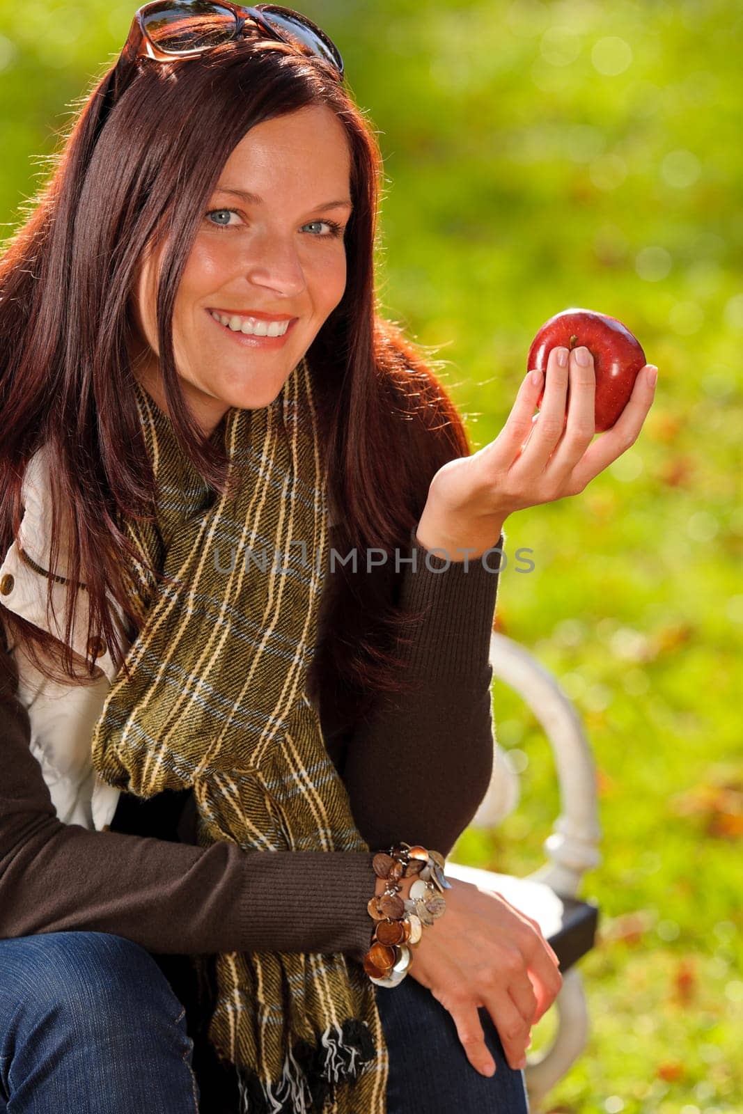 Autumn fashion smiling beautiful woman eat apple sunset nature park