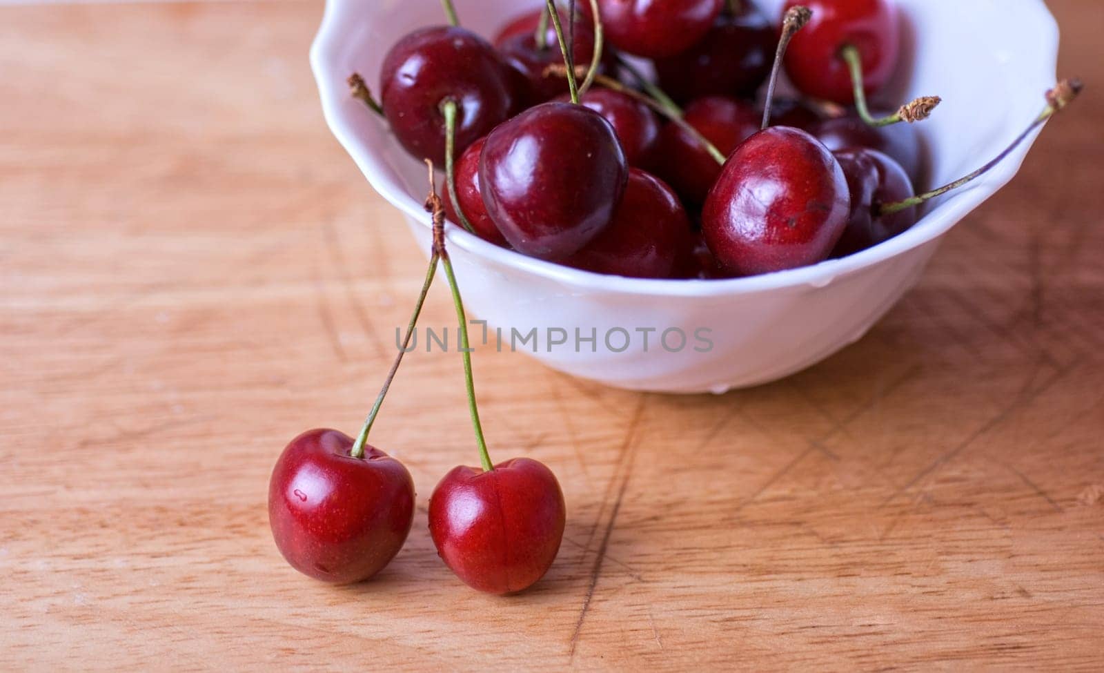ripe cherries on the wood table