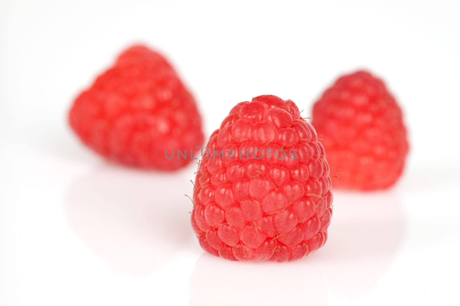 Raspberries on a white background