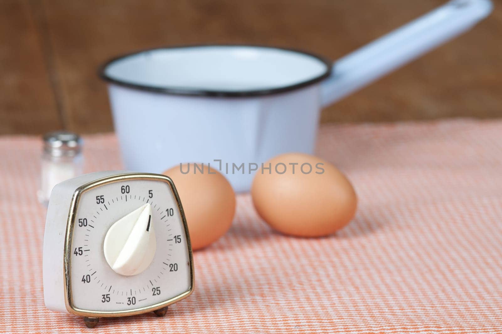 Two eggs with pot and egg timer