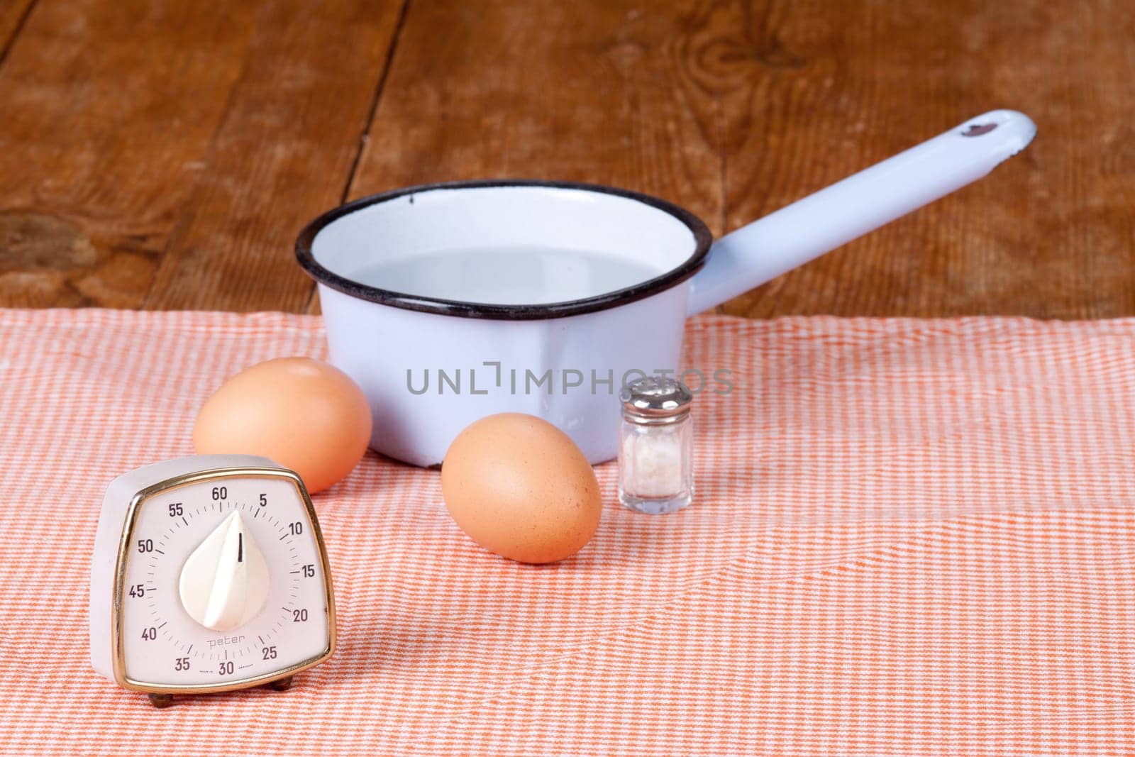 Two eggs with pot and egg timer